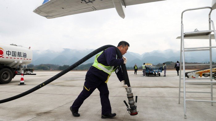 Jet fuel prices soar in Europe as war in Middle East threatens supplies Man with aviation fuel pump