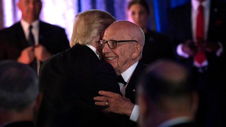 Donald Trump and Rupert Murdoch hugging.