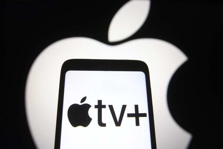 Apple TV+ price jumps 30% to $12.99 monthly In this photo illustration an Apple TV+ logo is seen on a smartphone screen with an Apple logo in the background.