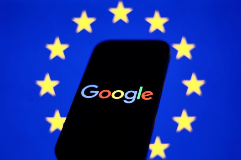 EU fines Google $3.5B over adtech ‘abuse’ European Union flag displayed on a laptop screen and Google logo displayed on a phone in front of it