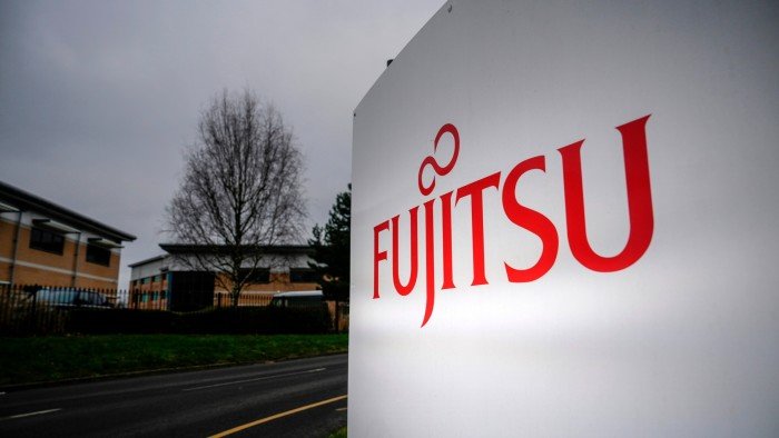 Boss of company linked to Post Office scandal gets 50% pay rise Fujitsu company sign outside office buildings on a cloudy day in Warrington, England.