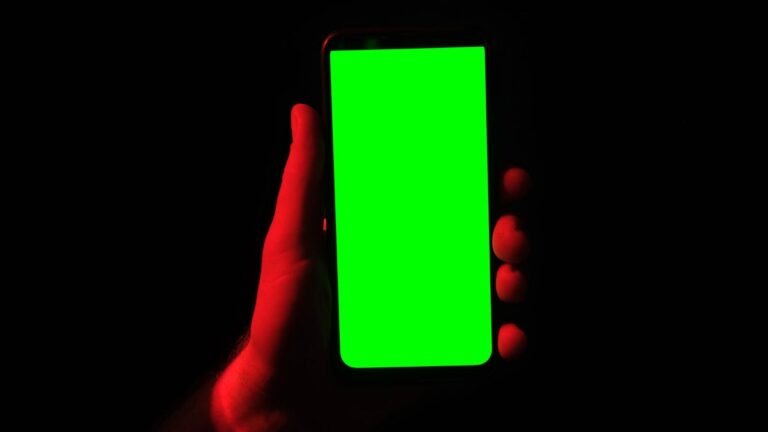 Bright neon screen on phone with dark background