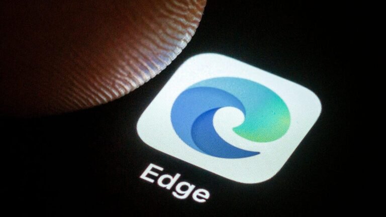 Not to Be Outdone by ChatGPT Atlas, Microsoft Enhances Copilot Mode in Its Edge Browser A person's thumb hovers over the Microsoft Edge phone icon.