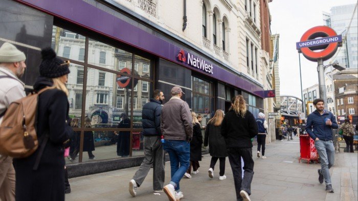 Bankers see off Chancellor’s raid but remain vigilant People walk past a NatWest branch in the City of London, with a London Underground sign visible nearby.
