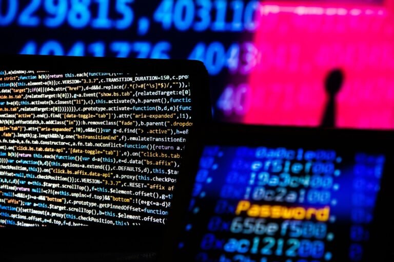 Computer code and text displayed on computer screens.