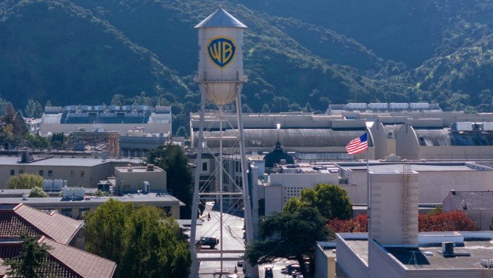 Warner Bros to reject $108bn Paramount hostile offer The Warner Bros. studio lot with the iconic water tower and an American flag, seen from above.